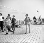 ID 1252 FLAVIA (1947/15495grt/IMO 5116139, ex-MEDIA. Renamed FLAVIAN, LAVIA) - Youngsters enjoy a game of shuffleboard on the Lido Deck while the ship was en-route to Papeete, Tahiti from Balboa, Panama.